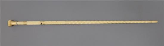 A 19th century ebony inset whale bone walking stick, with marine ivory knop, 36in.